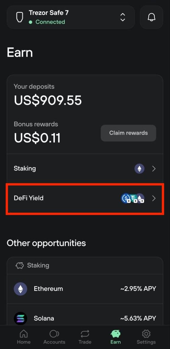 Trezor Suite Earn overview shows $909.55 in deposits, $0.11 in bonus rewards, and links to staking and DeFi Yield.